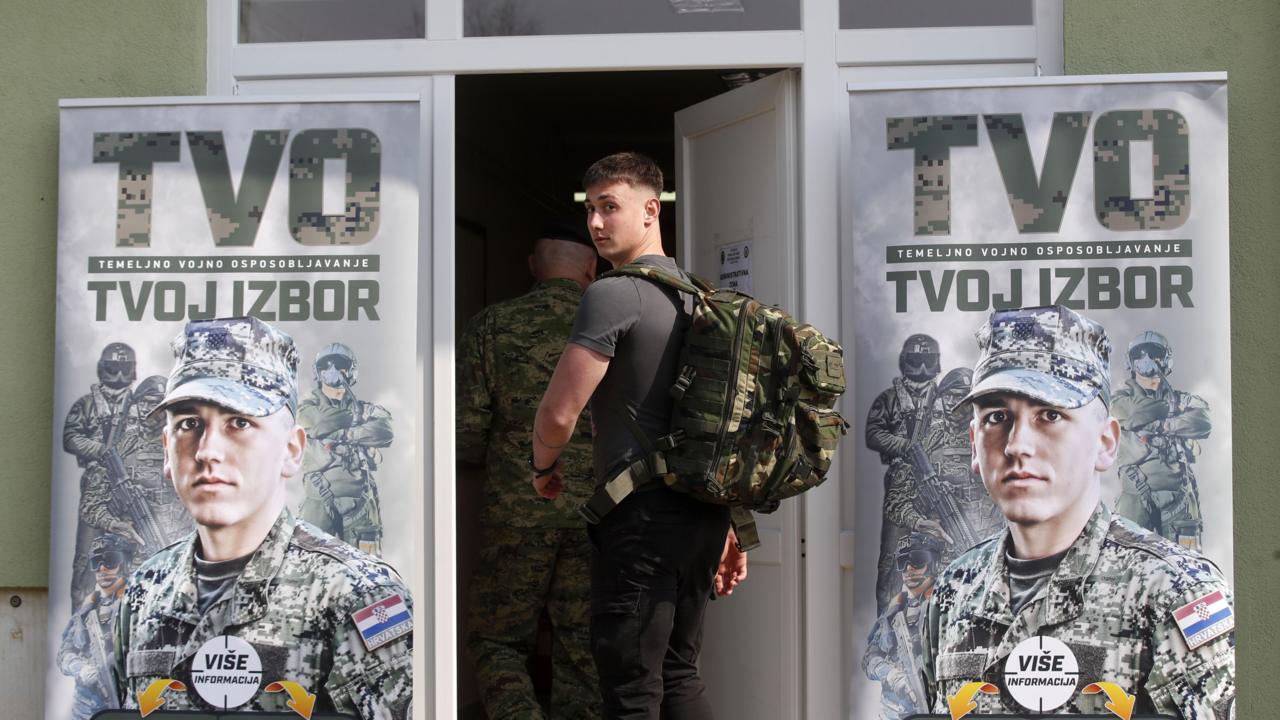 Young Croatian conscript walking into a military barracks