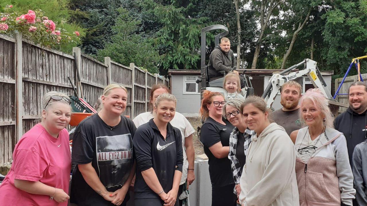 A group of volunteers in Stacey and Isla's garden