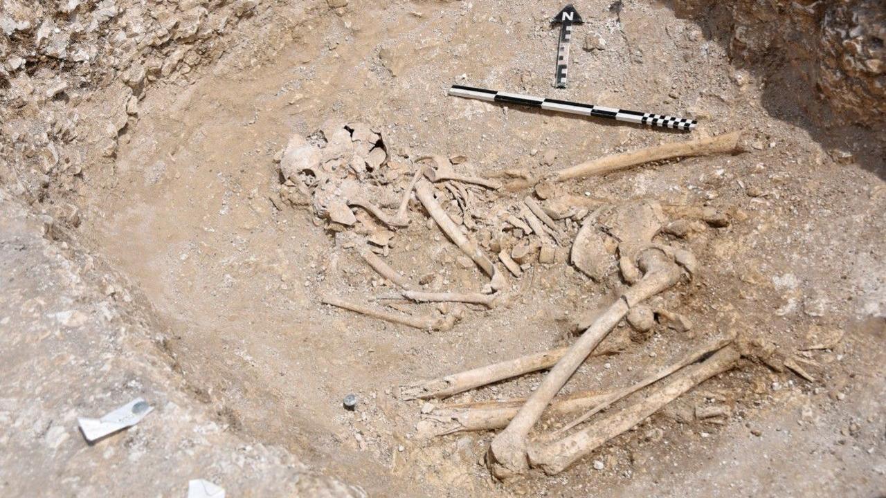 A partially excavated skeleton in a foetal position