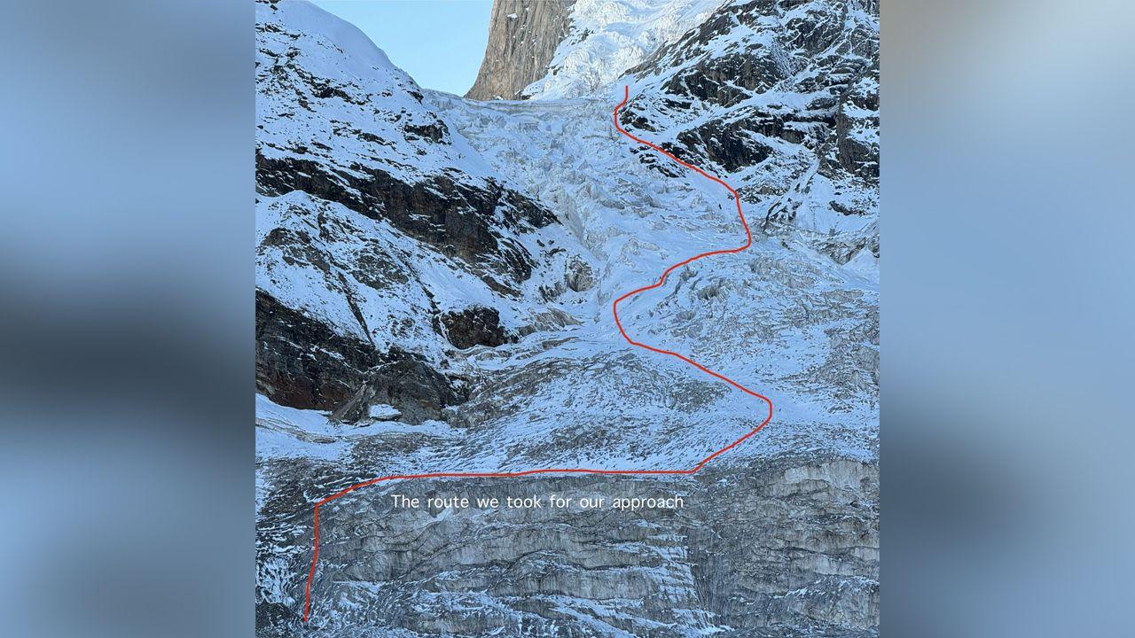 A photo of a steep ice covered mountain face with a red line drawn across it and labelled "the route we took for our approach"