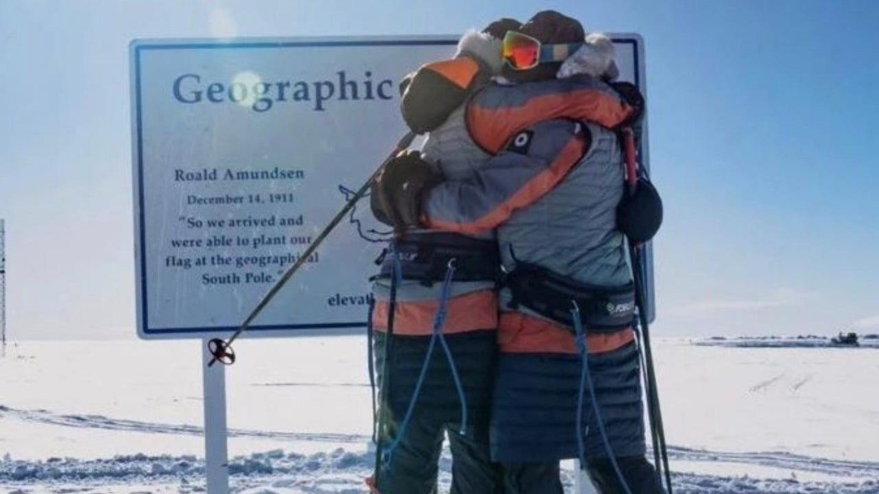 Rebecca Openshaw-Rowe and Georgina Gilbert hugging at the South Pole.