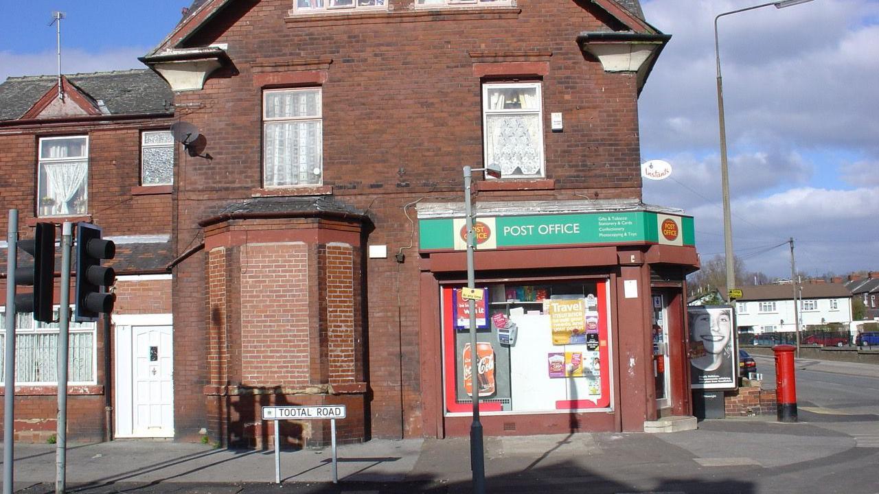 A side view of the building housing the Post Office branch on Tootal Road, Salford