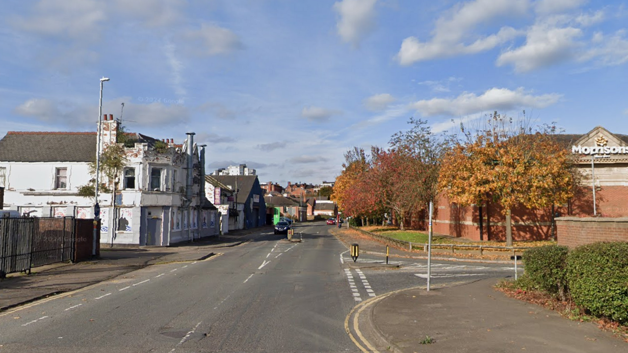 A view of Cattle Market Road heading towards South Bridge on Google streetview. There is a white building on the right and a Morrisons supermarket on the left. 