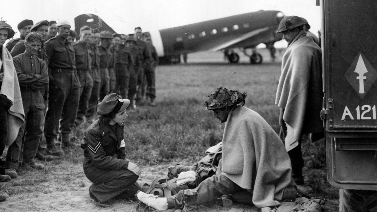 Corporal Lydia Alford tending to wounded British soldiers at B2/Bazenville airfield in Normandy, 13 June 1944