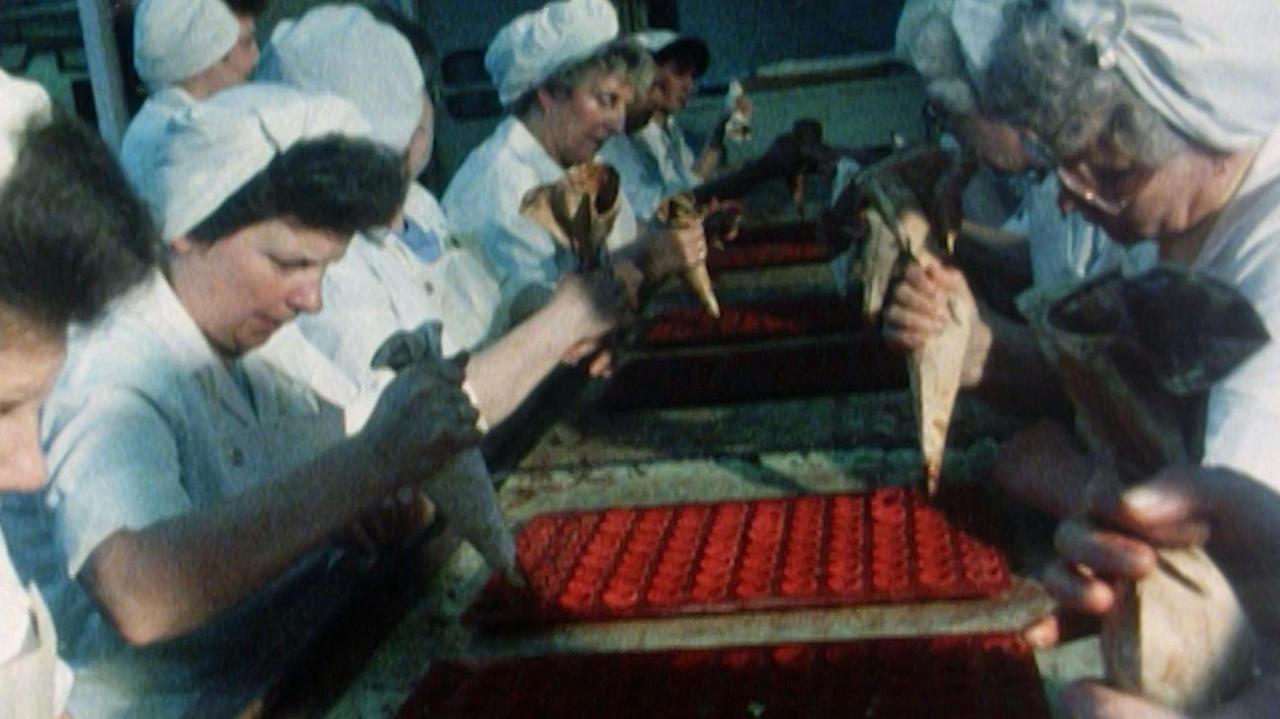 Image from archive footage of women working at Rowntree's chocolate factory.