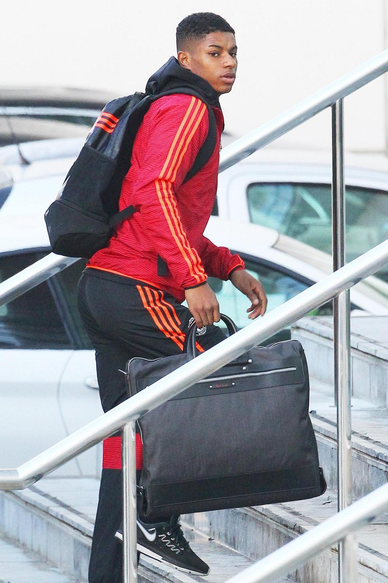 A teenage Marcus Rashford climbs some steps