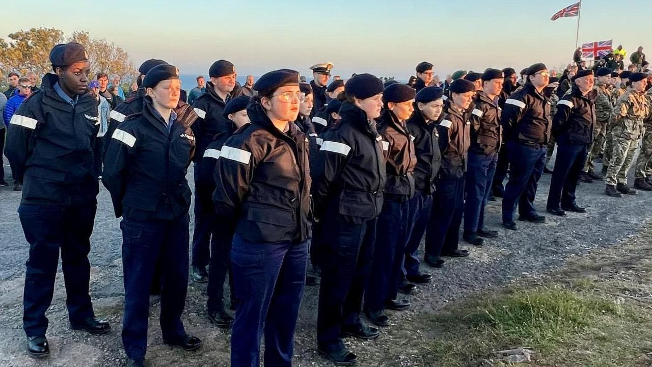 Cadets stand in formation and at attention at the cemmorations