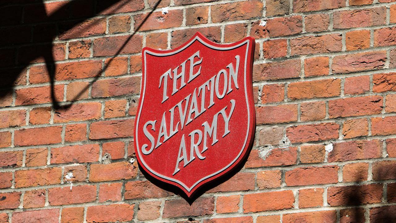 A bright red shield with Salvation Army written across it in italics. 