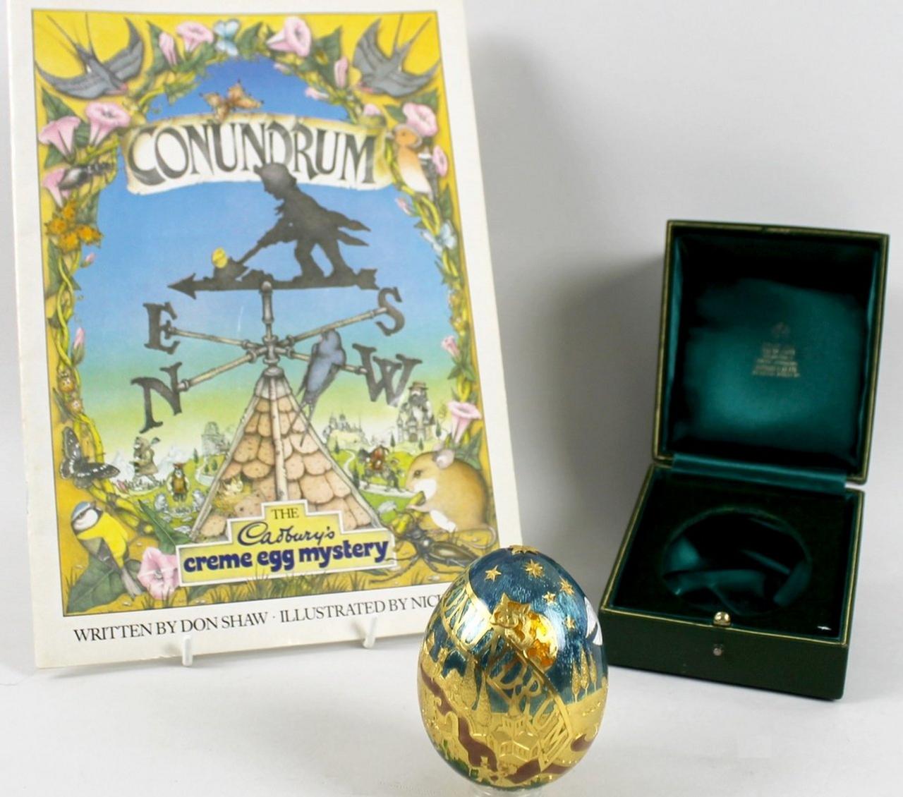 The gold egg is for sale in its original green embossed presentation box and includes a copy of Conundrum written by Don Shaw, illustrated by Nick Price and published by Hamlyn in 1983