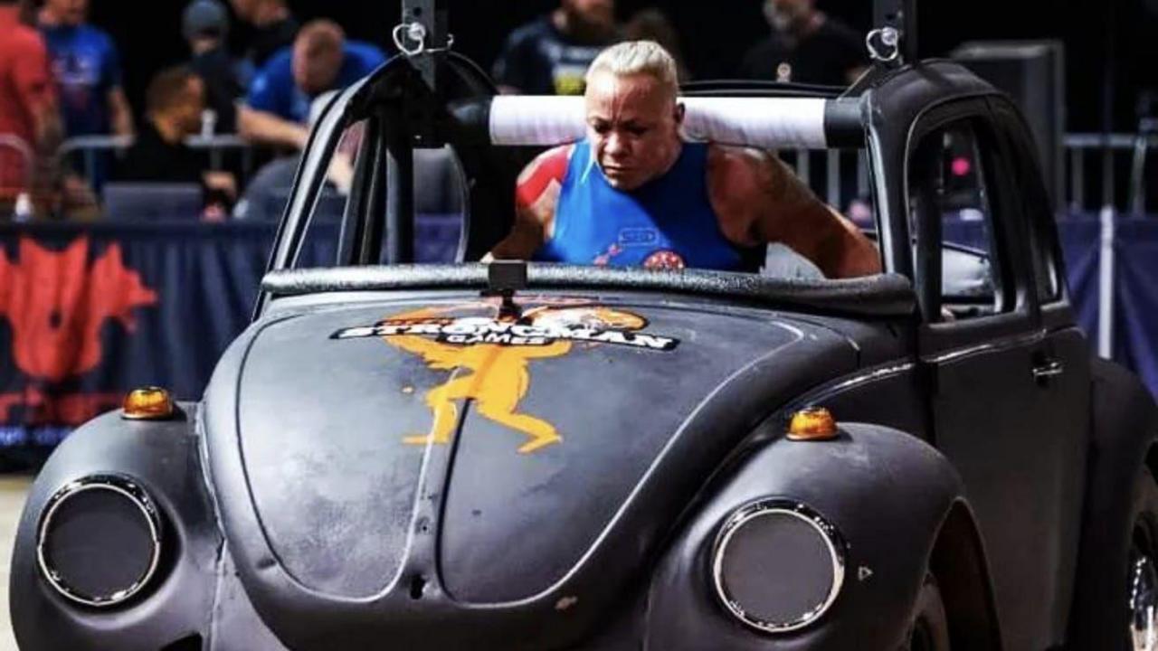 Sue Taylor-Franklin carrying a car as part of a competition