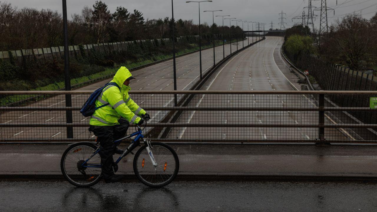 Cyclist crossing bridge over the M25