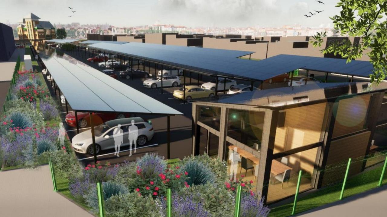 Solar panels in the photo look like two long roofs over car parking spaces.