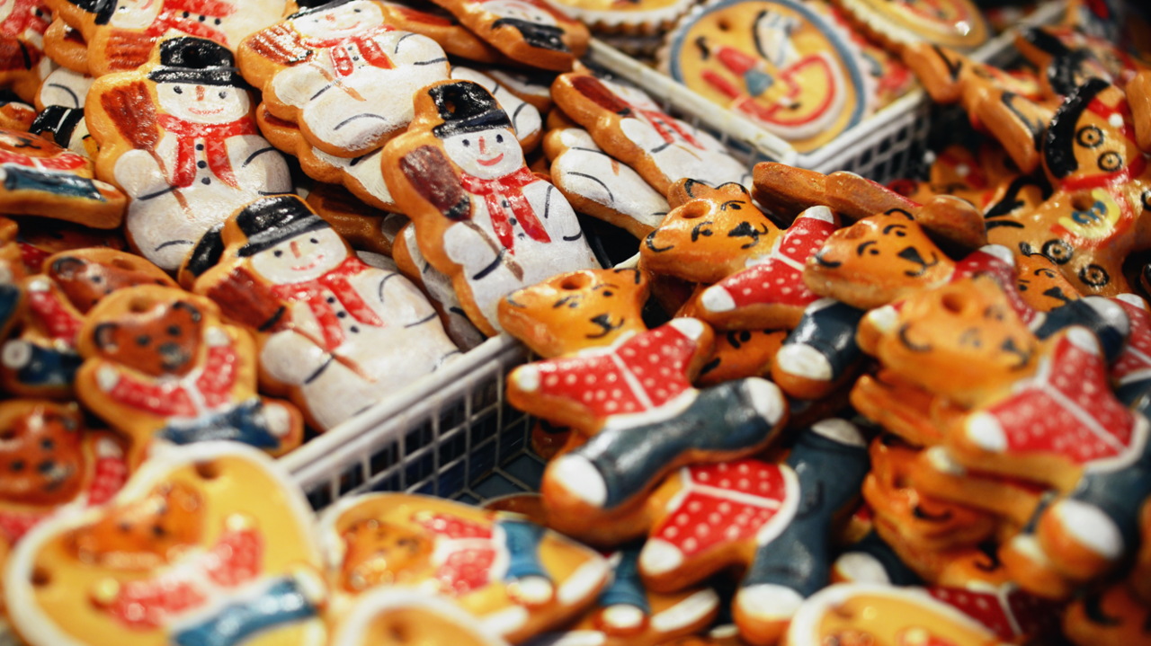 Handmade Christmas decorations to hang on a Christmas tree. They are for sale in a market, with teddies and snowmen in the image.