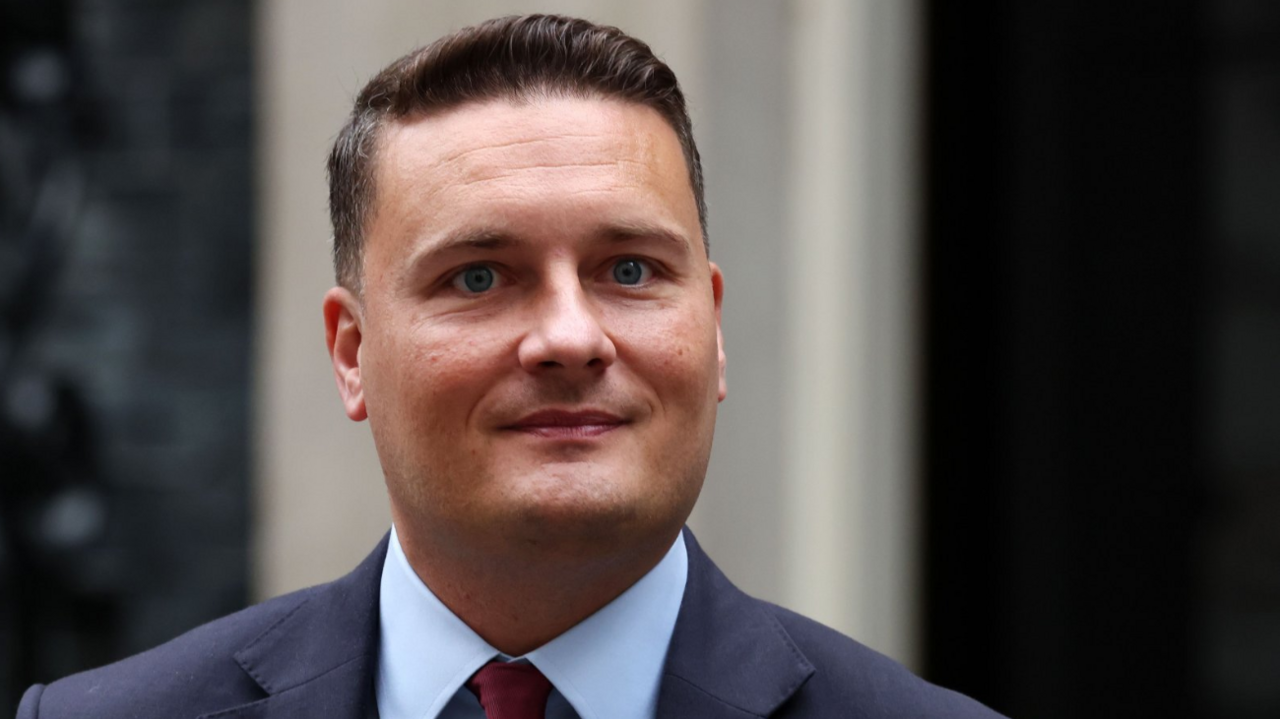 Health Secretary Wes Streeting stands outside 10 Downing Street, wearing a blue shirt and a navy suit