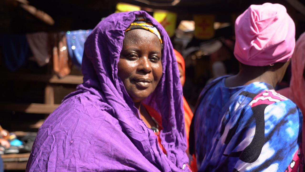 Assitan Diarra, smiles, wearing a purple headscarf