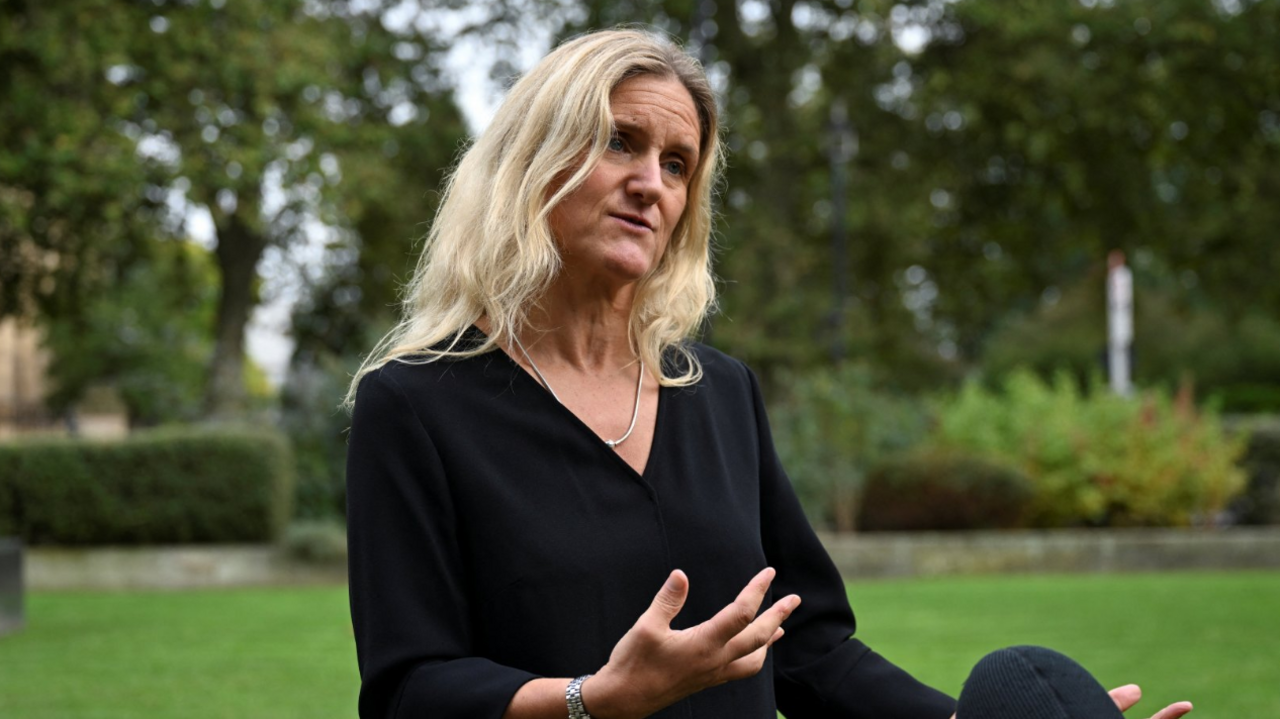 Kim Leadbeater speaking about the Assisted Dying Bill in Westminster. She wears a black dress and a simple gold necklace.