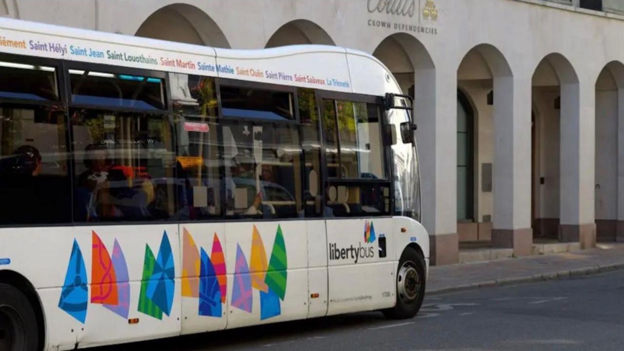 A LibertyBus vehicle in front of a building.