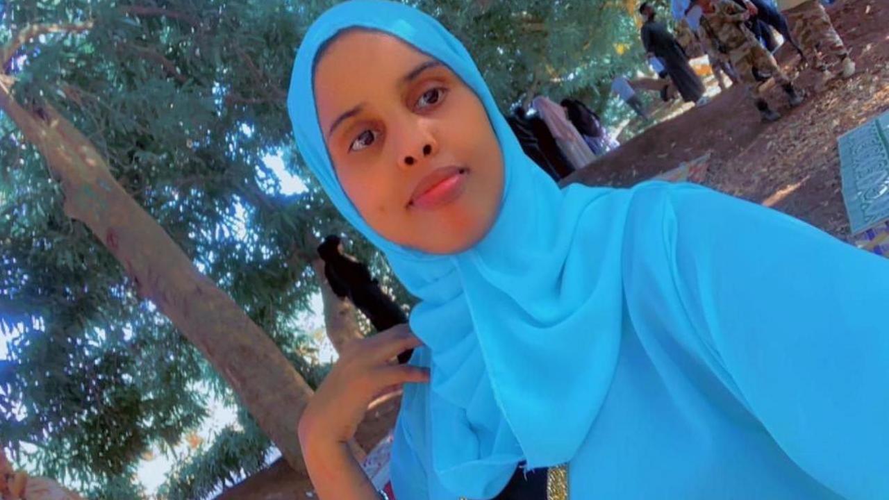 Fathi Hussein, posing for a selfie wearing a blue headscarf. 