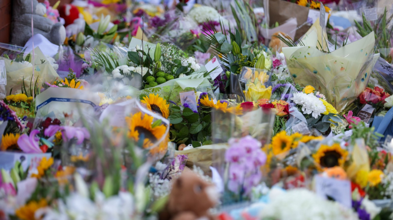 A picture of memorial flowers and teddy bears laid in memory of the three victims of the Southport attack. 
