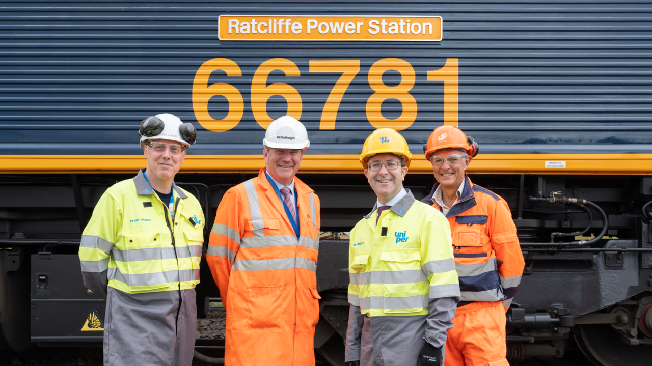 Four men in front of train