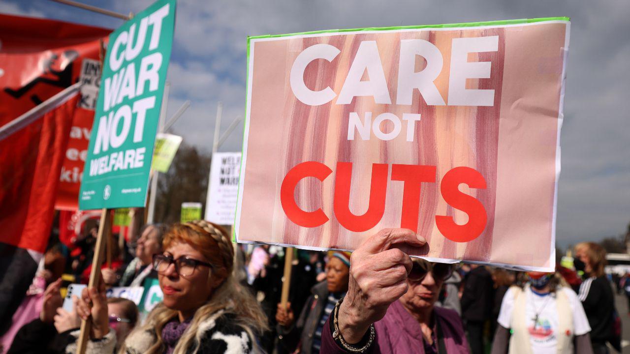 Protesters demonstrate against disability and welfare cuts during the announcement of the Spring Statement outside Parliament in London in March. They hold up placards reading: "Care not cuts".