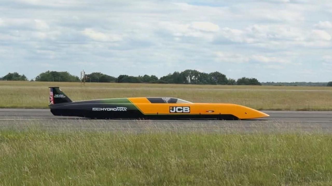 JCB Hydromax stationary on a track.