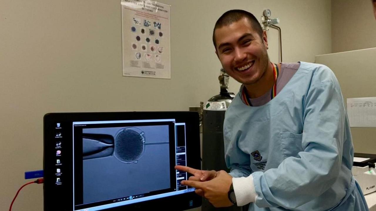 Scientist Patricio Palacios points at a kangaroo embryo on a computer screen