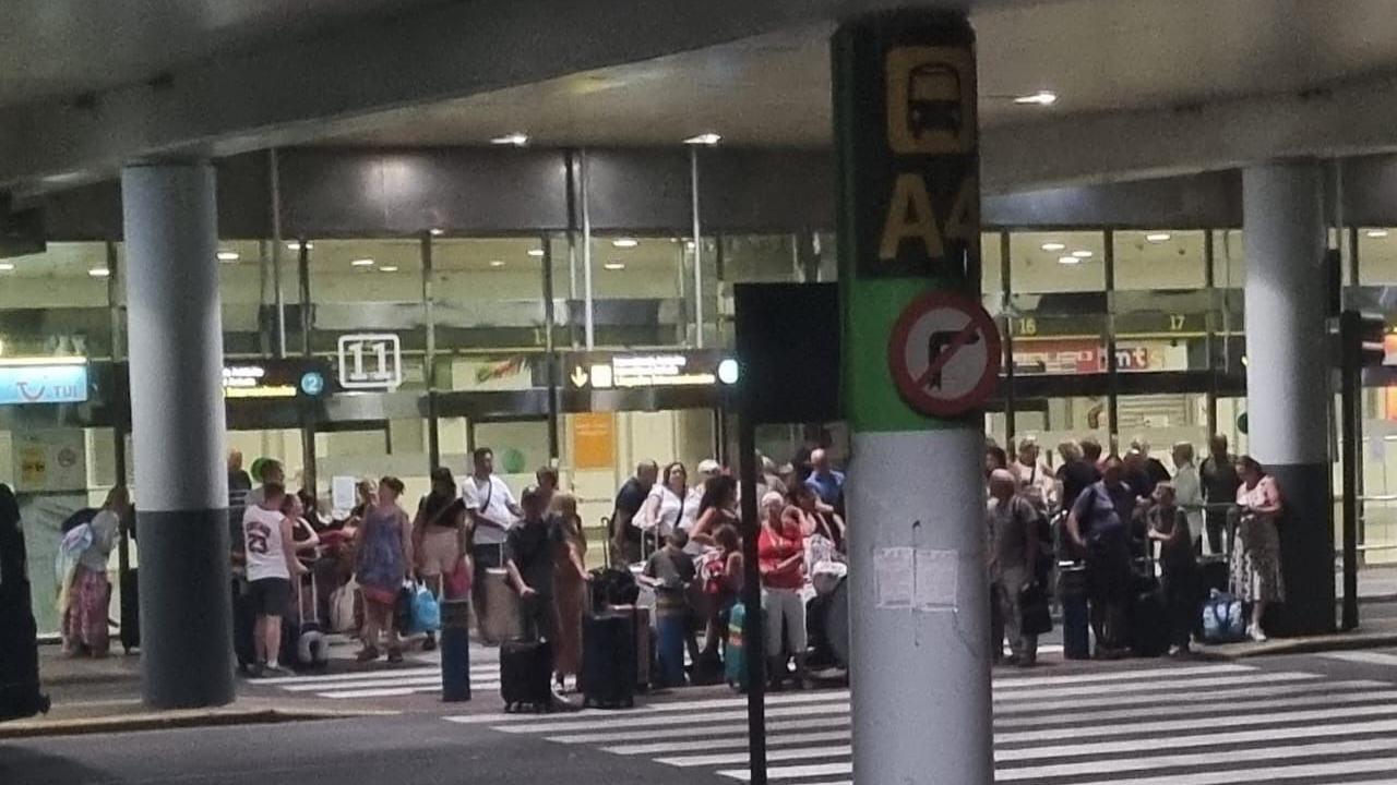 Tui passengers waiting with suitcases and luggage