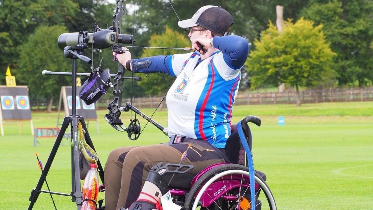 A woman in a wheelchair playing archery