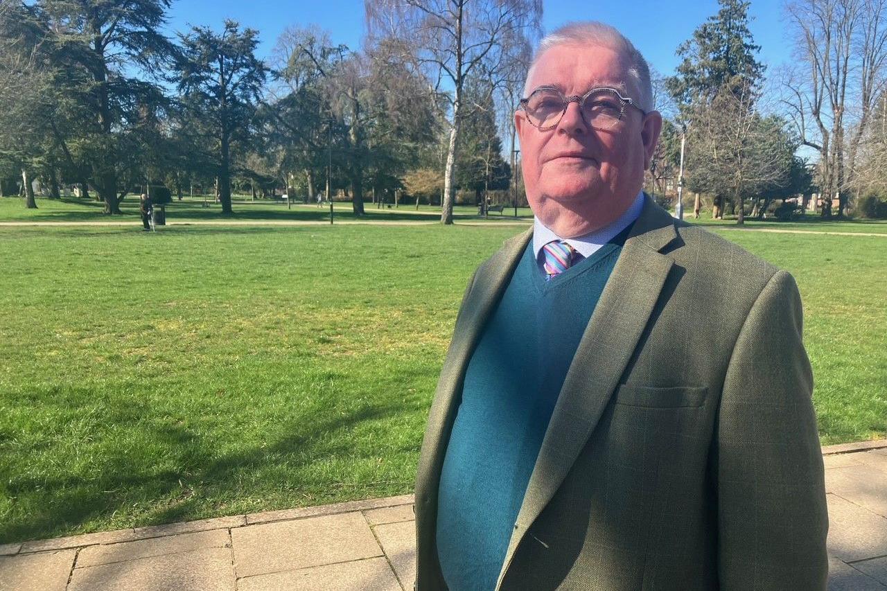 Labour candidate John Tizard in a suit, jumper and tie, looking at the camera