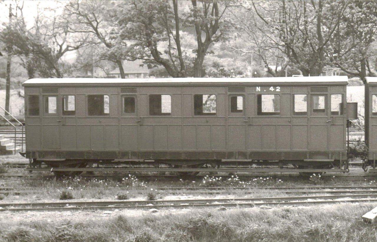 A dark carriage with a white roof in the countryside, takne in 1955