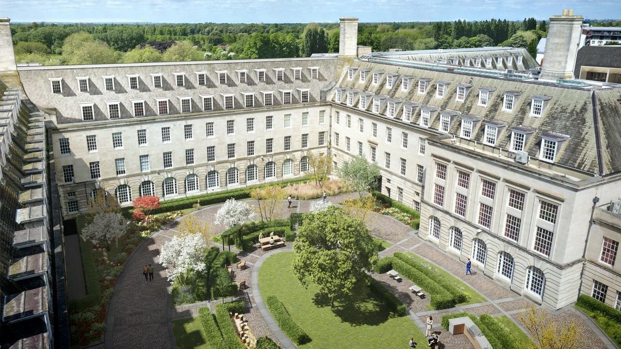 A generated aerial image from above the development, overlooking a green area in a courtyard and the traditional building.