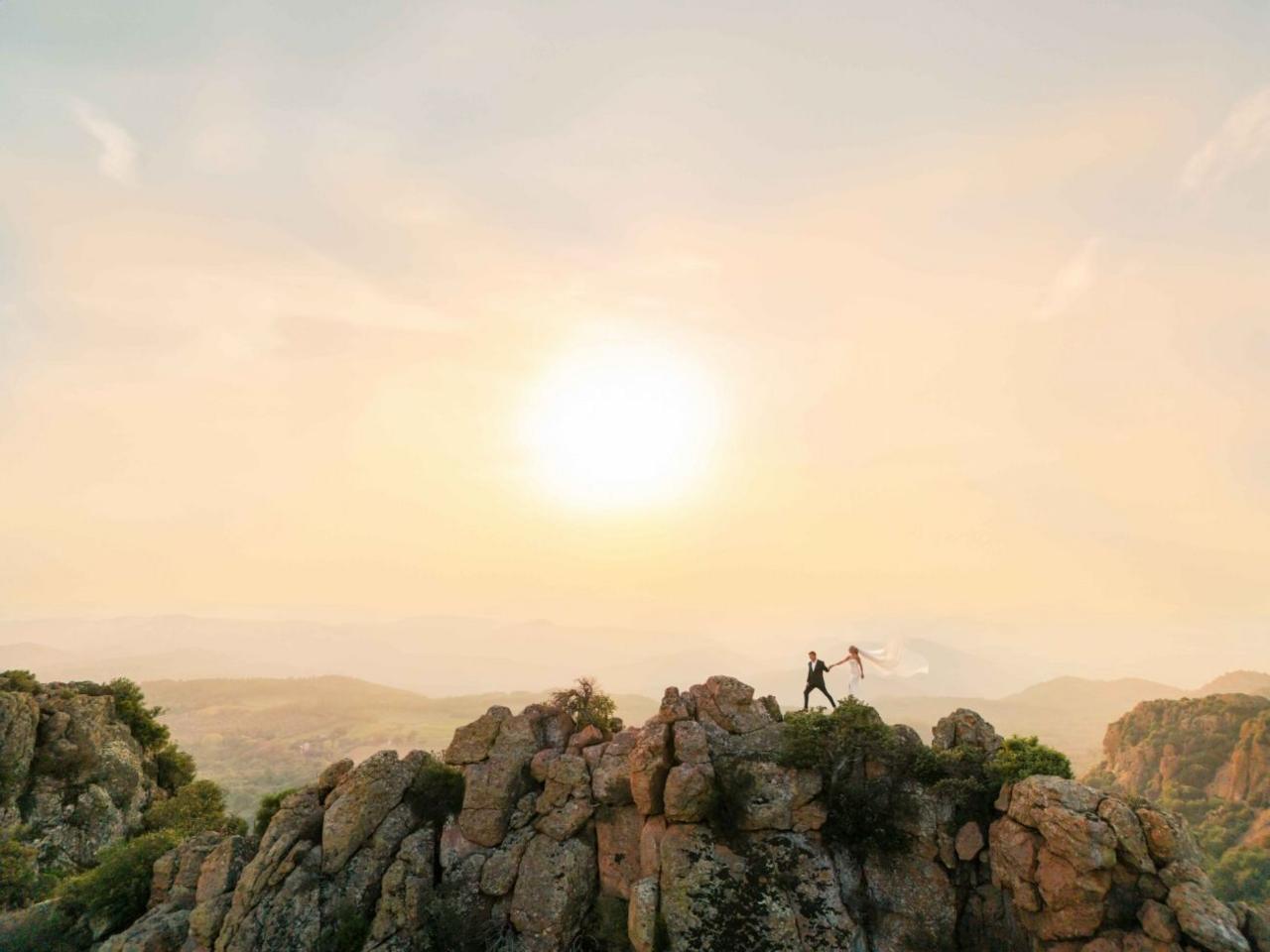 Wedding couple on a high rock