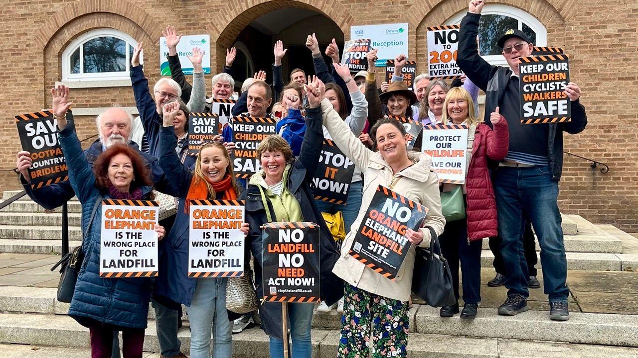 Campaigners against the landfill plans outside County Hall with placards
