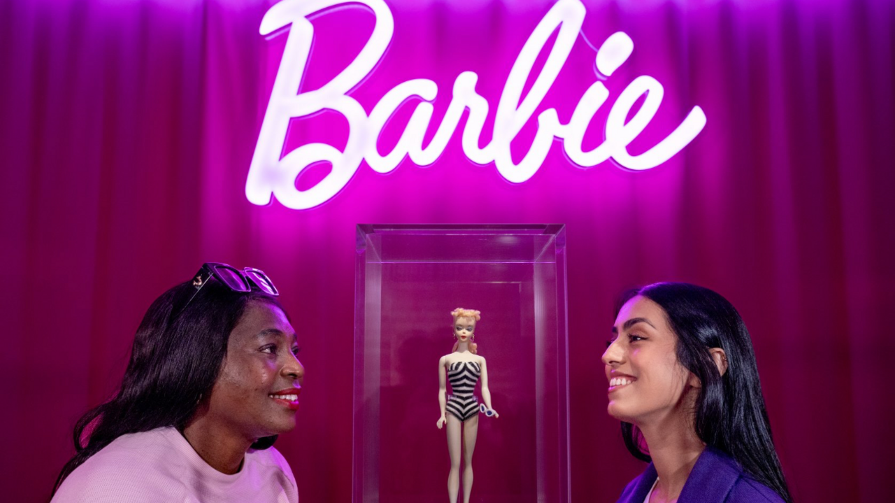 Two woman take a closer look at the very first Barbie doll from 1959 on display during a preview of in Barbie: The Exhibition at Kelvingrove Art Gallery and Museum in Glasgow.