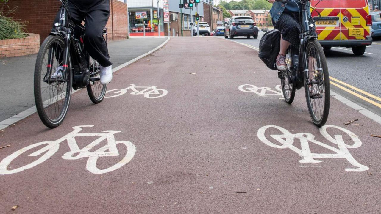 Two cyclists using the dedicated cycle lane in Nottingham