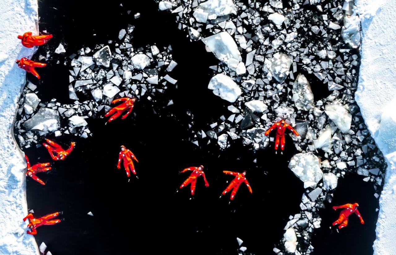 People floating in icy water