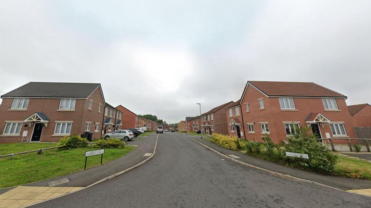 Streetview of Frosterley Drive. It is a street of two-storey houses, mixture of detached and semi-detached, made from red brick.