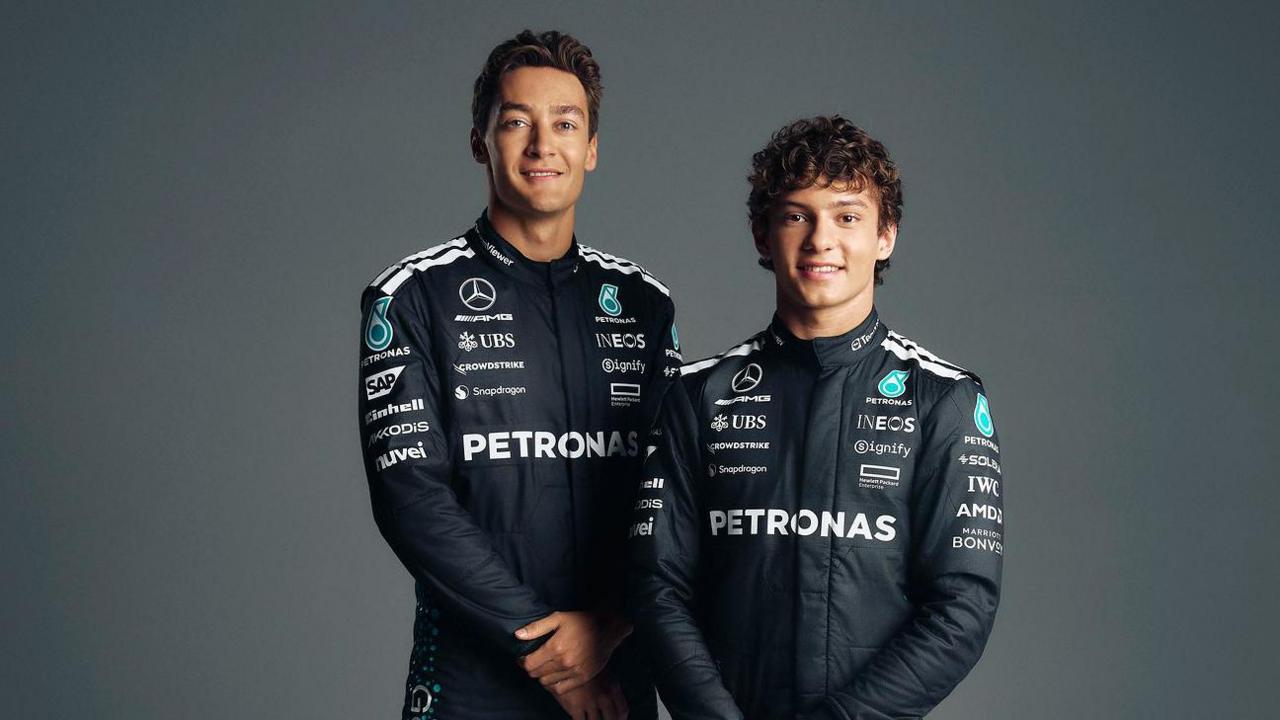 George Russell and Andrea Kimi Antonelli pose for photographs in their Mercedes race uniforms