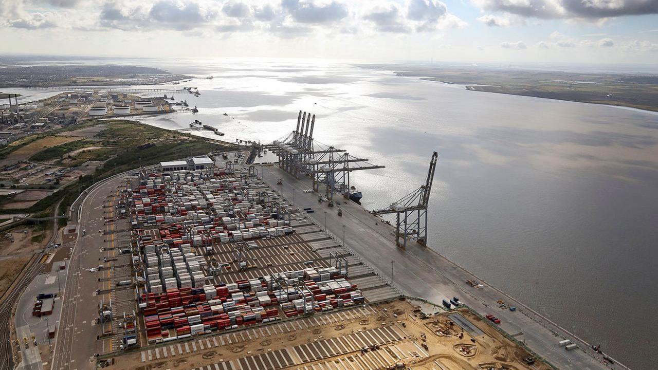 A wide aerial shot of DP World's London Gateway with the River Thames, many containers, and cranes visible