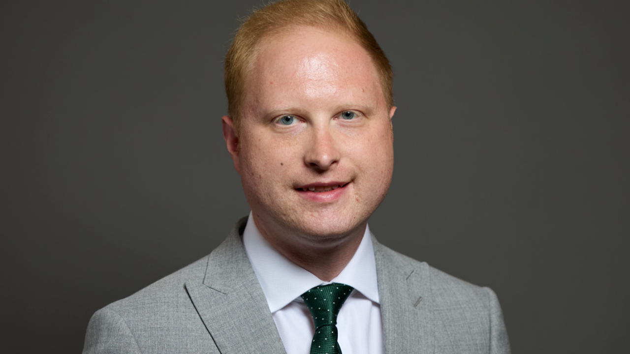 Man in suit with green tie