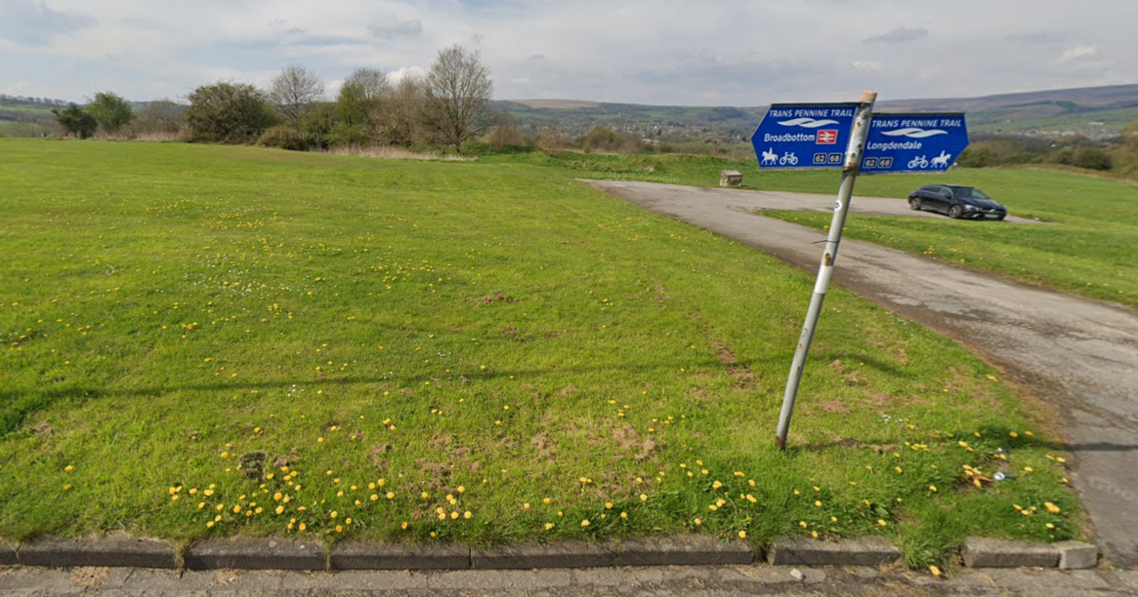 A grassy mound and adjoining car park near Glossop