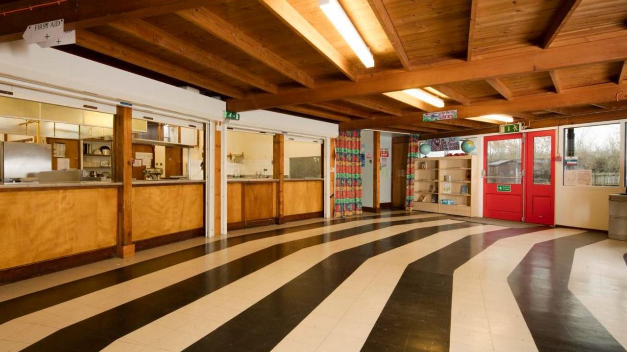 Inside of school building with black and white striped floor