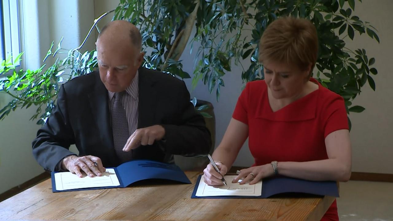 Jerry Brown and Nicola Sturgeon signing agreement