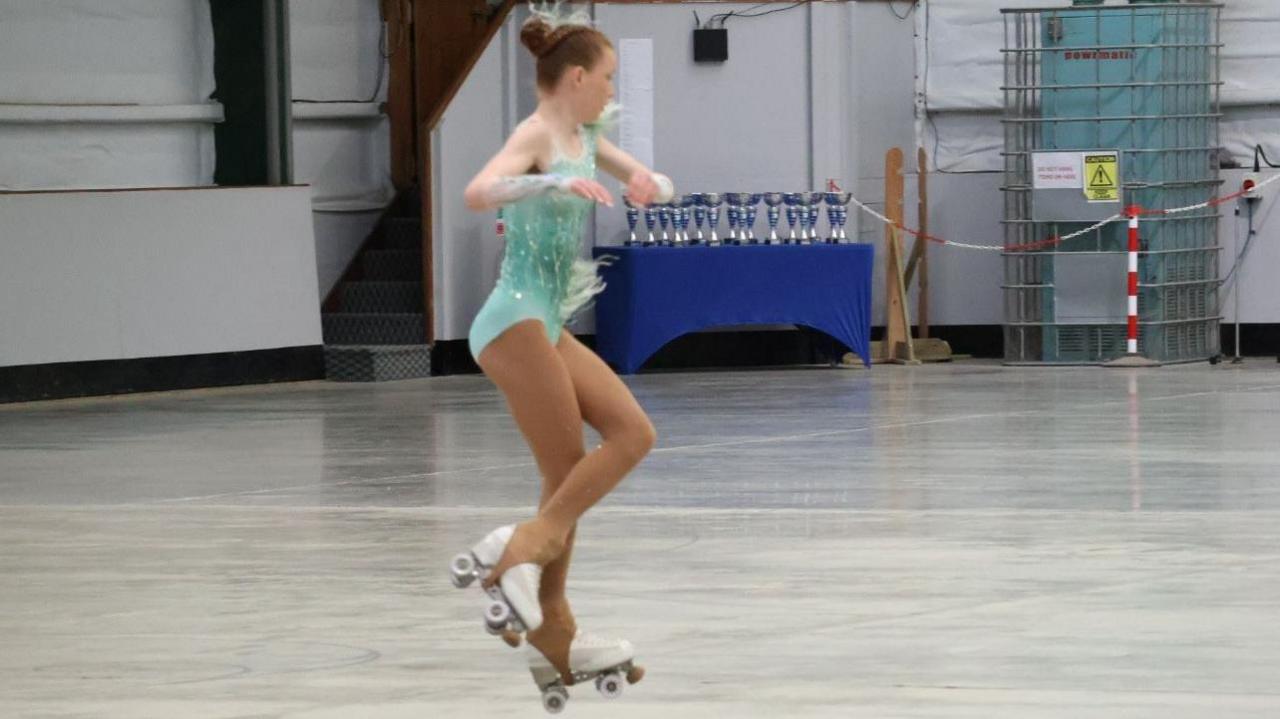 A girl performing an artistic roller-skating routine