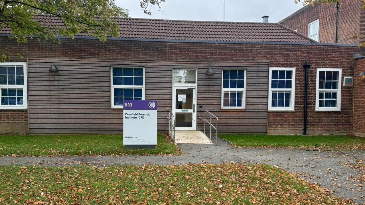 A one-storey building which has a sign outside saying "Cranfield Forensic Institute"