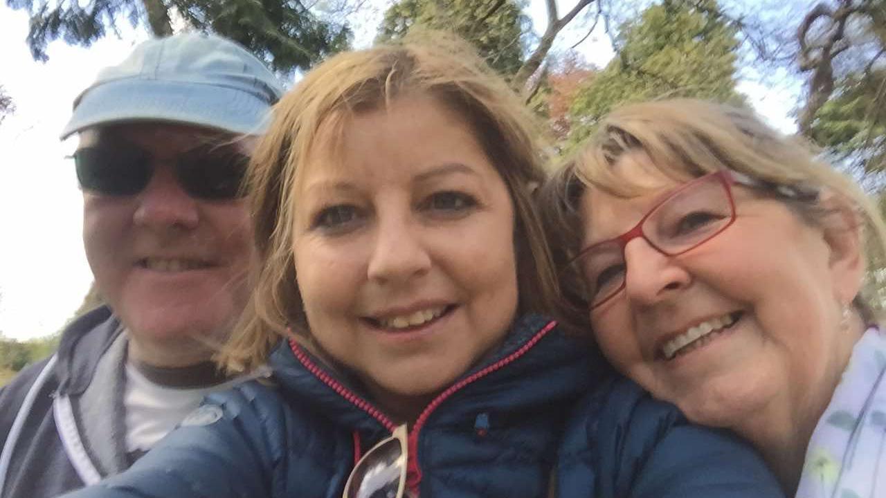 Allison (centre) smiles at the camera with her mum Helen (right) and father David (left) 