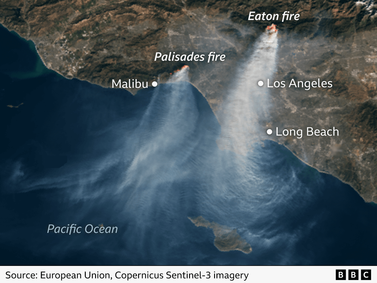 Satellite image of the California coastline showing the burning Eaton and Palisades fires and the huge plumes of smoke rising from them.