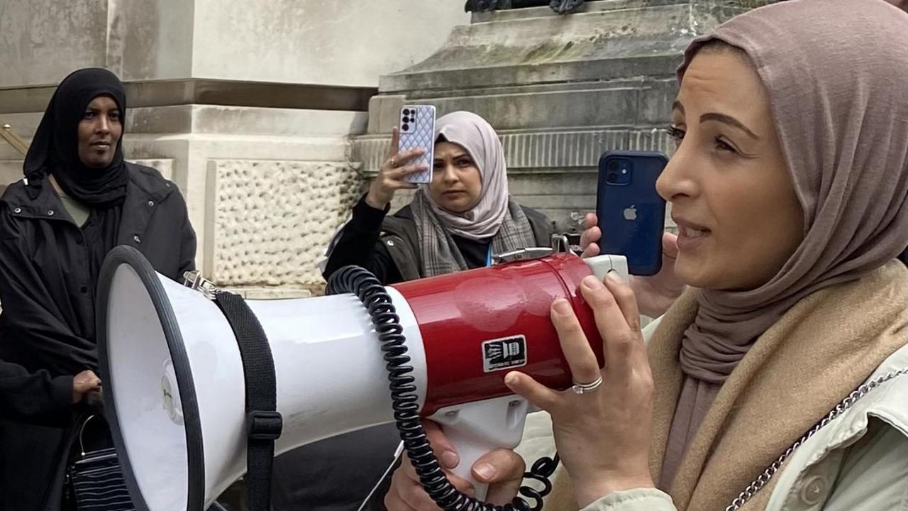 Hanan Yafaye speaking through a megaphone