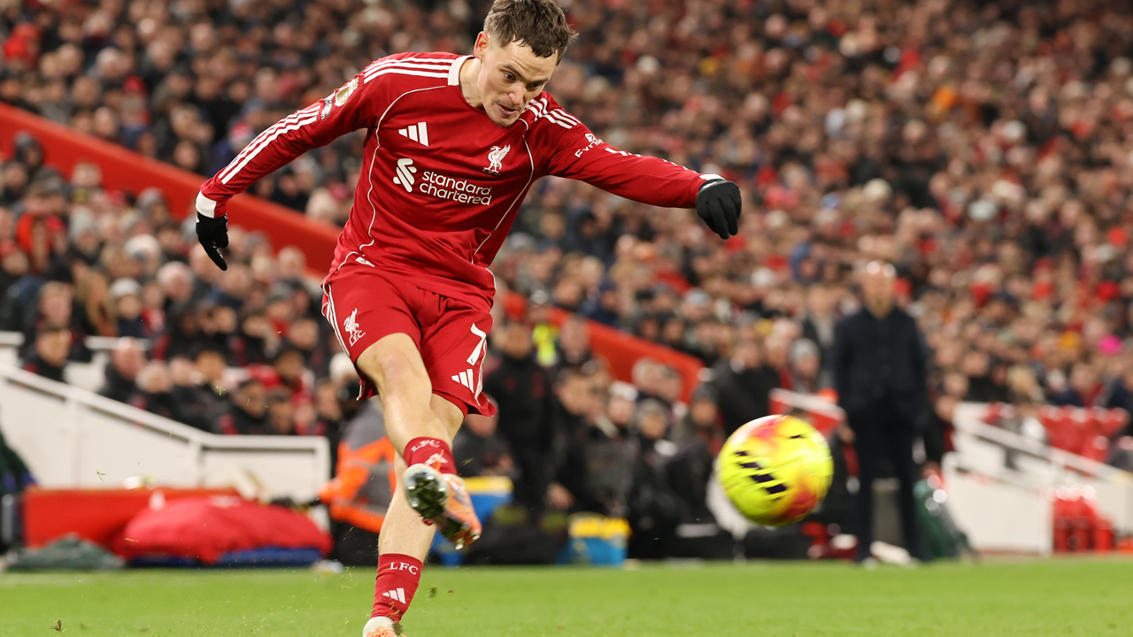 Florian Wirtz kicks the ball in a red Liverpool shirt